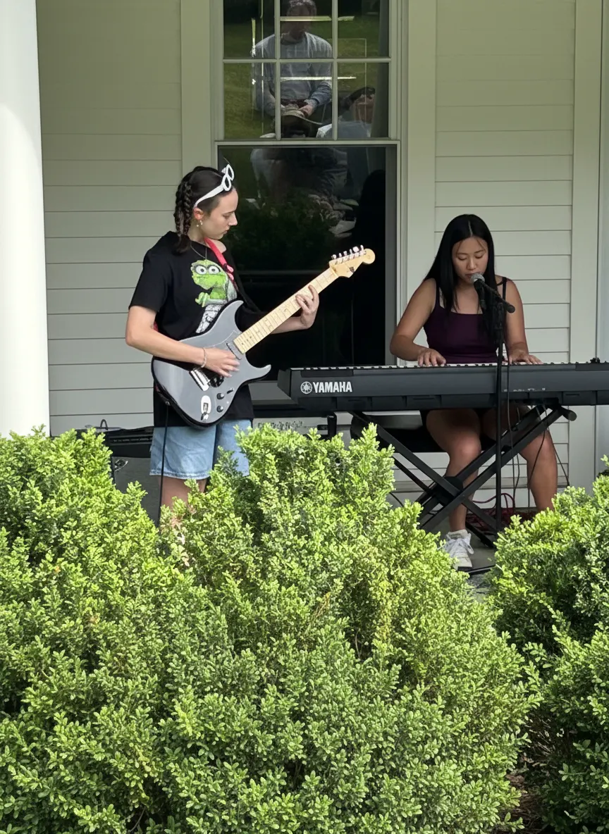 Students playing guitar and keyboard outdoors