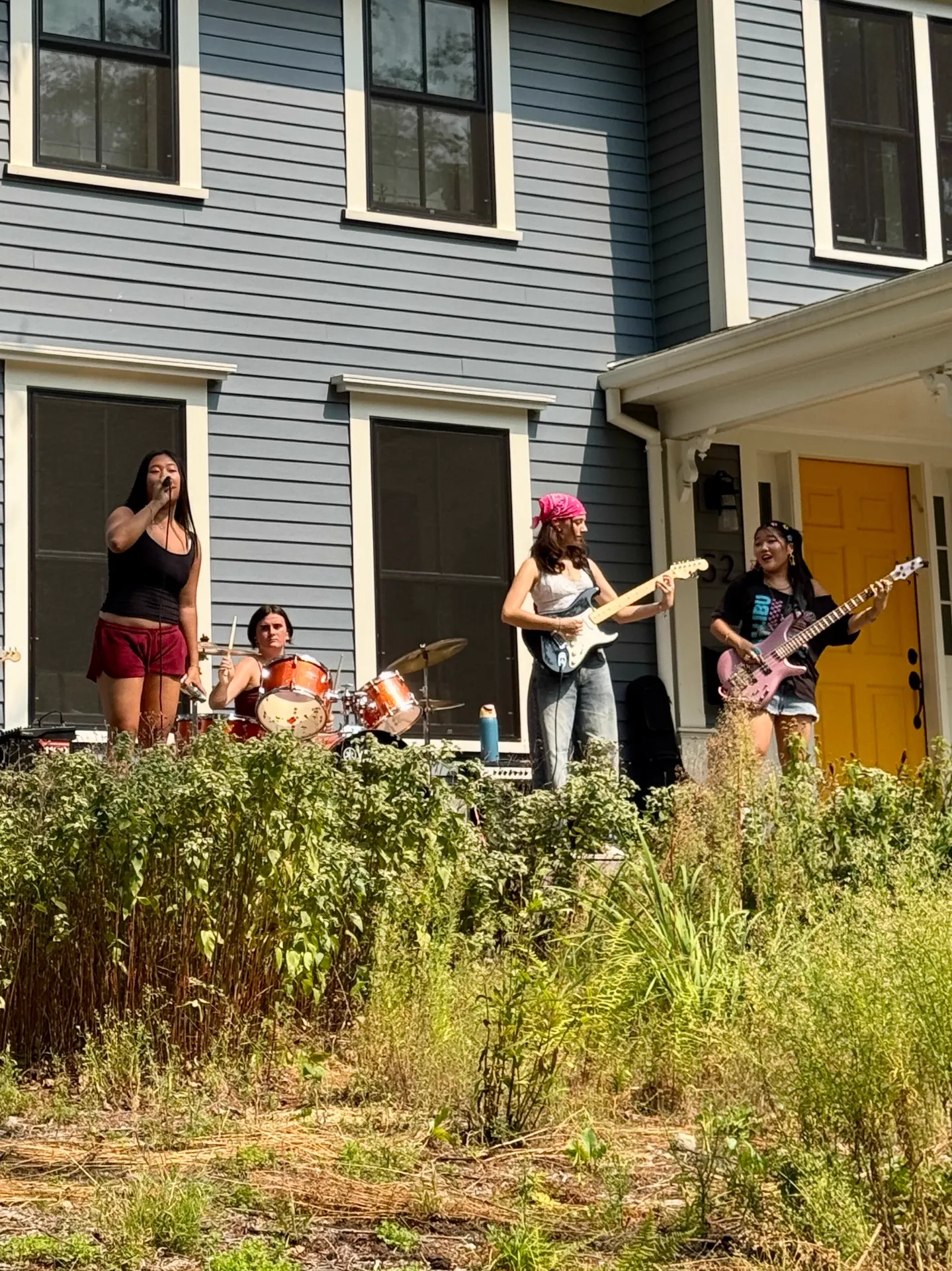 Student band performing outdoors on a sunny day