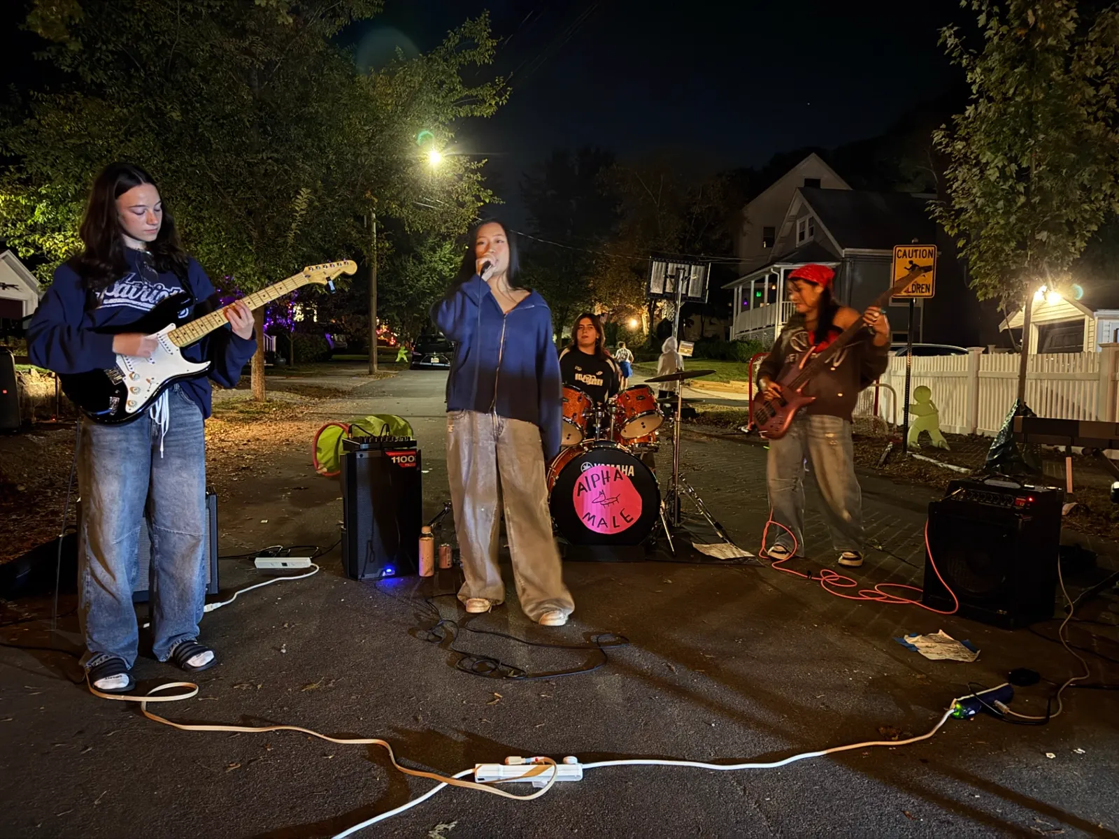 Student band performing at night with drums and guitars