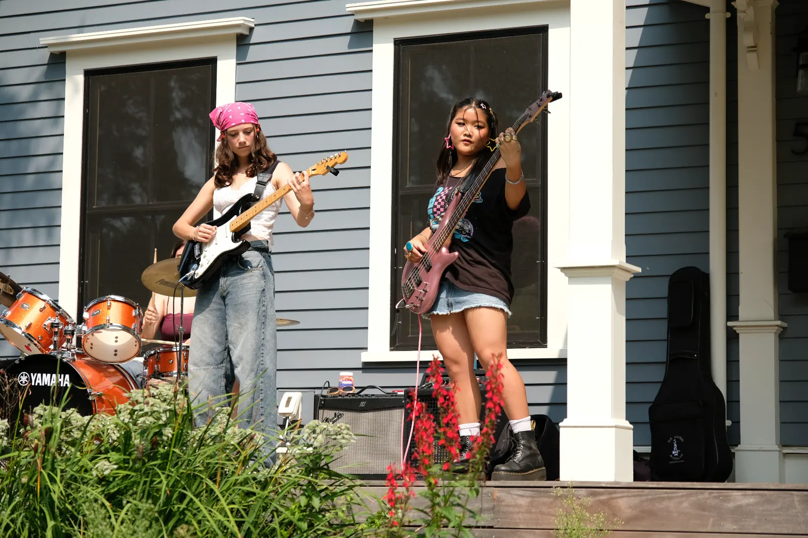 Guitar and bass players performing outdoors close-up
